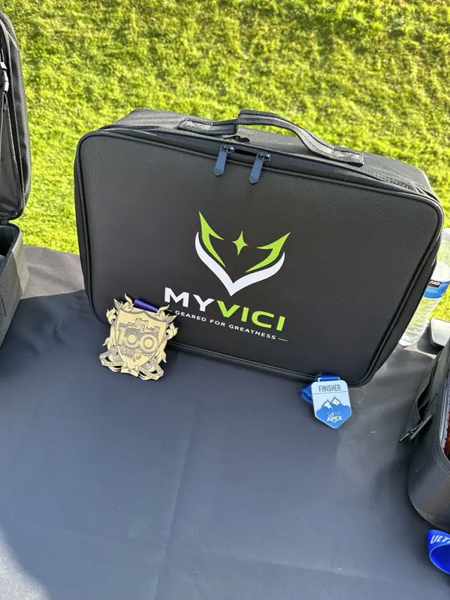 The current black MYVICI Running Organiser with white and lime branding, photographed closed at Scurry Events