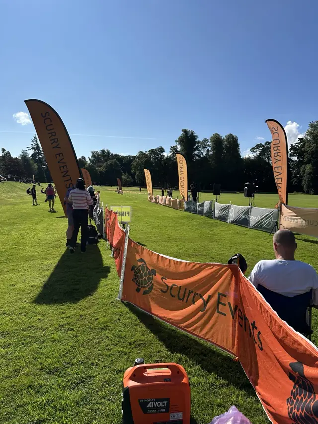 Runners and Scurry Events flags beside the finish area on race day in Scotland